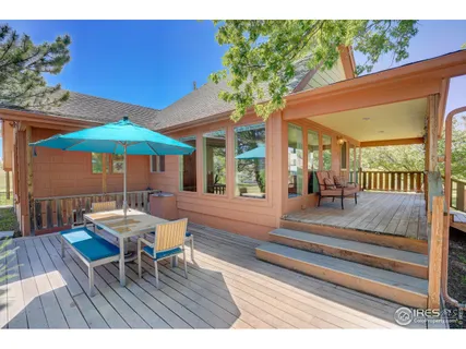 a view of a chairs and table on the wooden deck
