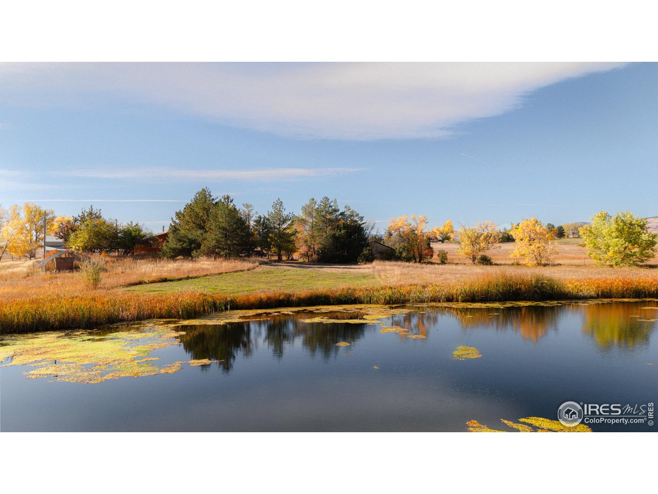 5196 Oxford Road Longmont, CO 80503 - Photo 7 of 38 a view of a lake with houses in the back