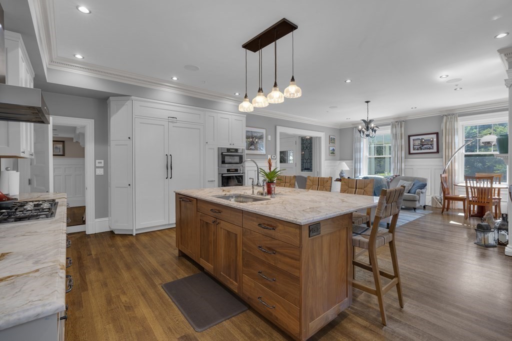23 Eliot Street, Unit 1 Boston, MA 02130 - Photo 15 of 39 a large kitchen with cabinets a counter top space a sink stainless steel appliances and a chandelier