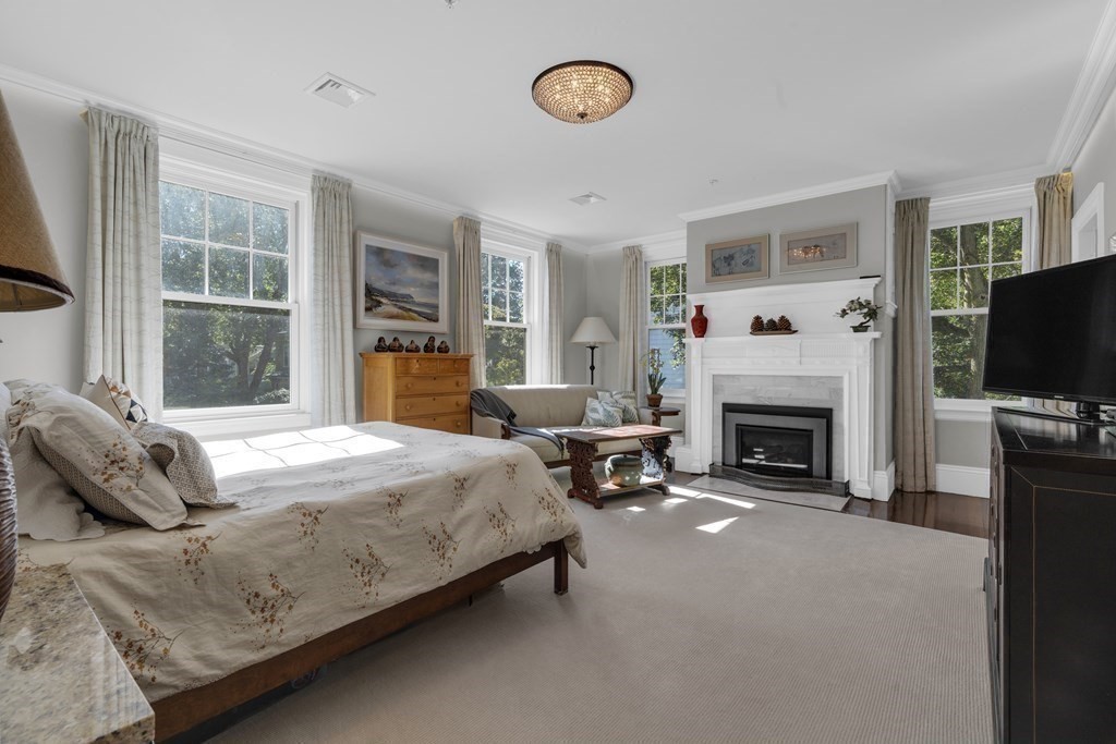23 Eliot Street, Unit 1 Boston, MA 02130 - Photo 22 of 39 a bedroom with a bed and a fireplace
