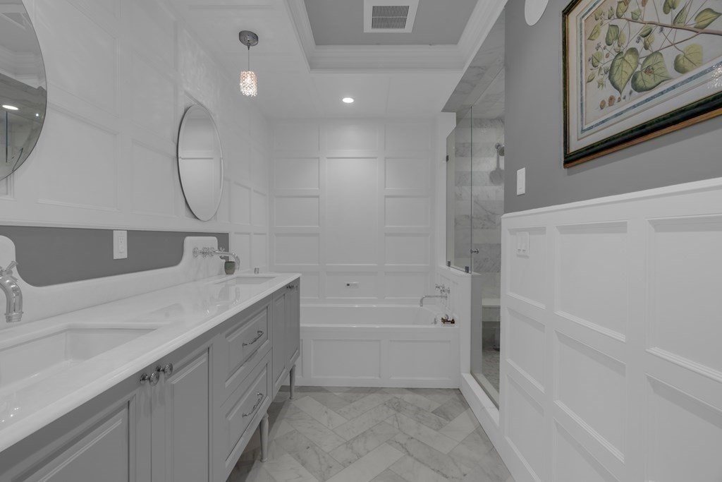 23 Eliot Street, Unit 1 Boston, MA 02130 - Photo 24 of 39 a spacious bathroom with a tub sink and mirror