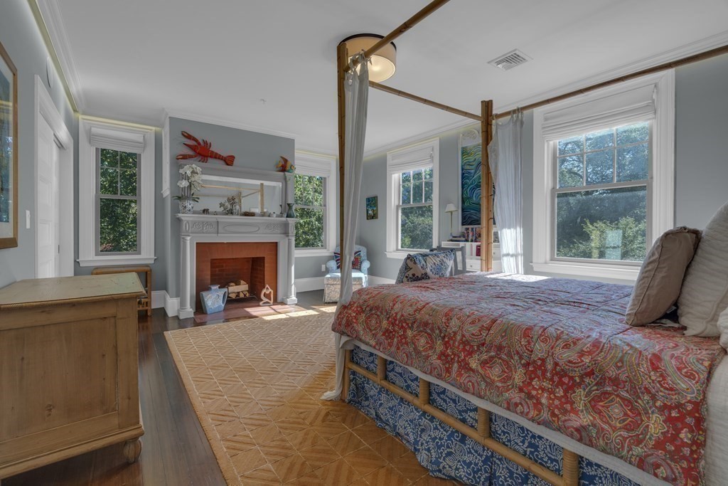 23 Eliot Street, Unit 1 Boston, MA 02130 - Photo 25 of 39 a bedroom with a bed and a fireplace