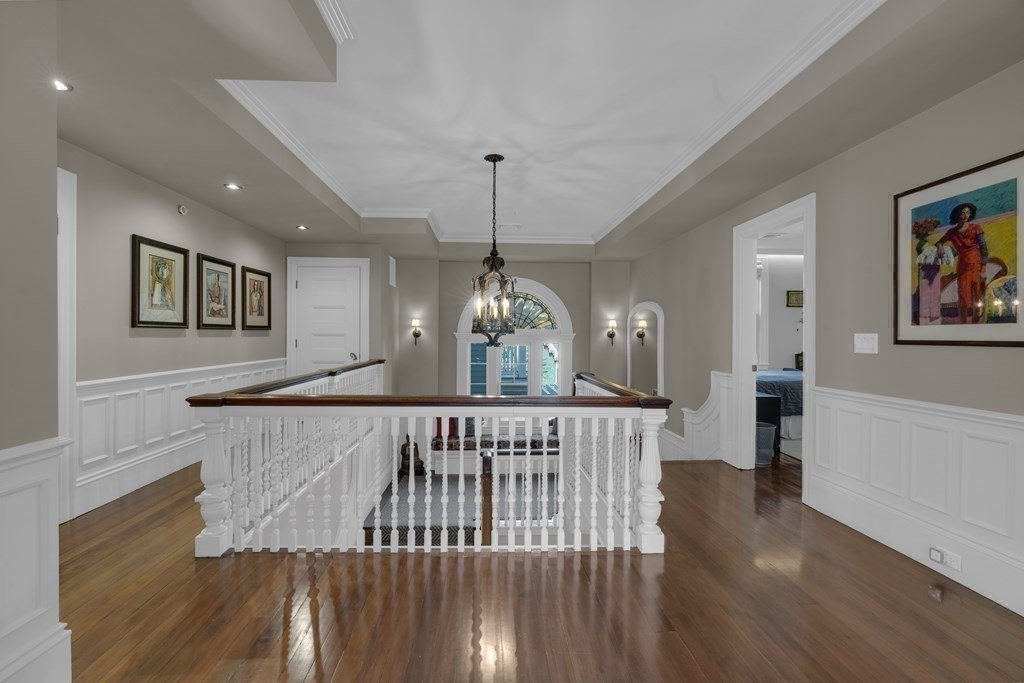 23 Eliot Street, Unit 1 Boston, MA 02130 - Photo 29 of 39 a view of a hallway with wooden floor and chandelier