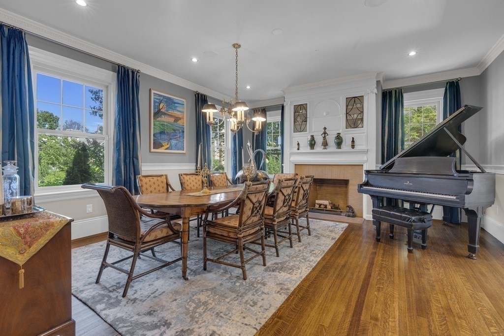 23 Eliot Street, Unit 1 Boston, MA 02130 - Photo 7 of 39 a dining room with furniture a rug a potted plant and a chandelier