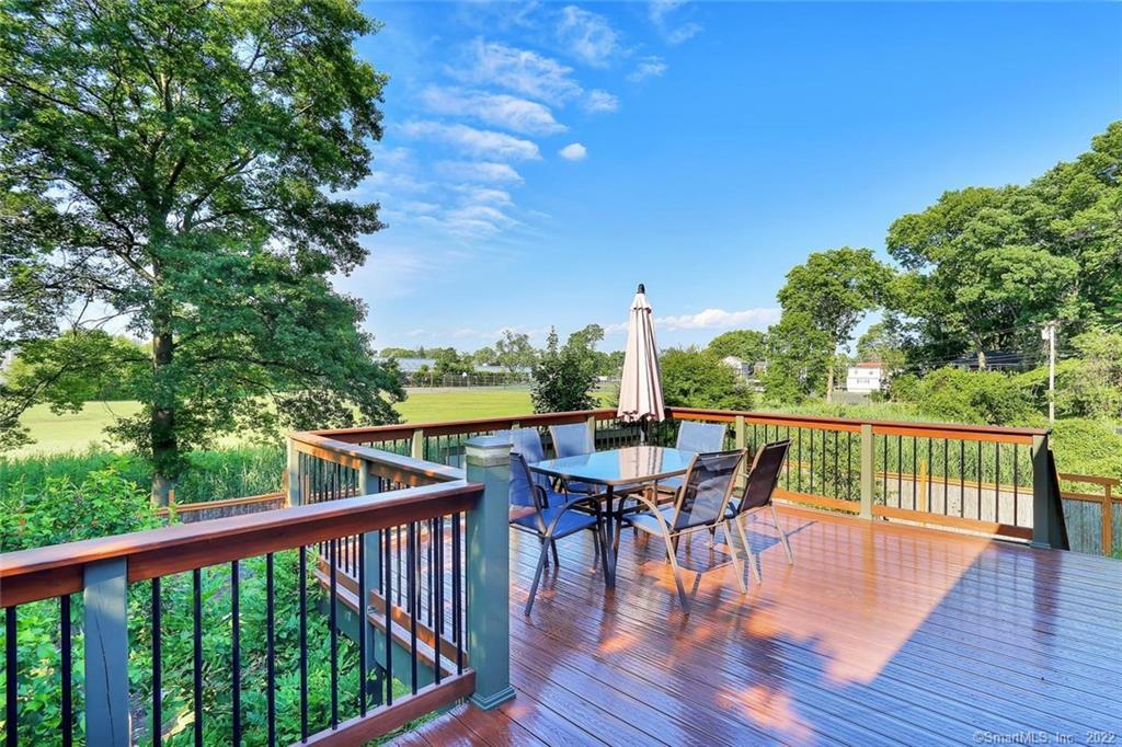 a view of balcony with furniture and wooden deck