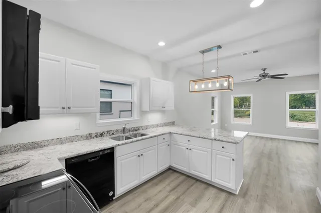 a kitchen with a sink stove and cabinets