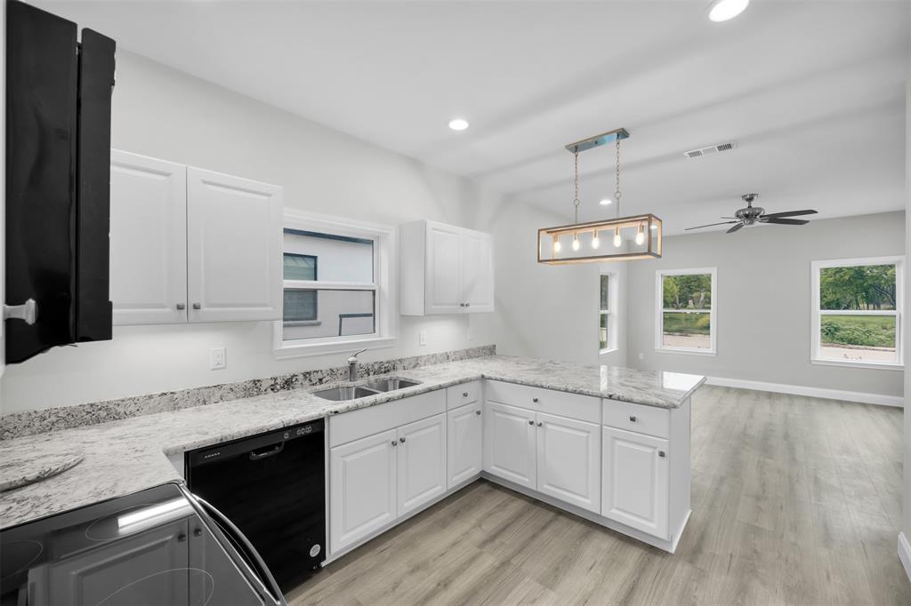 407 Dallas Street Rice, TX 75155 - Photo 11 of 25 a kitchen with a sink stove and cabinets