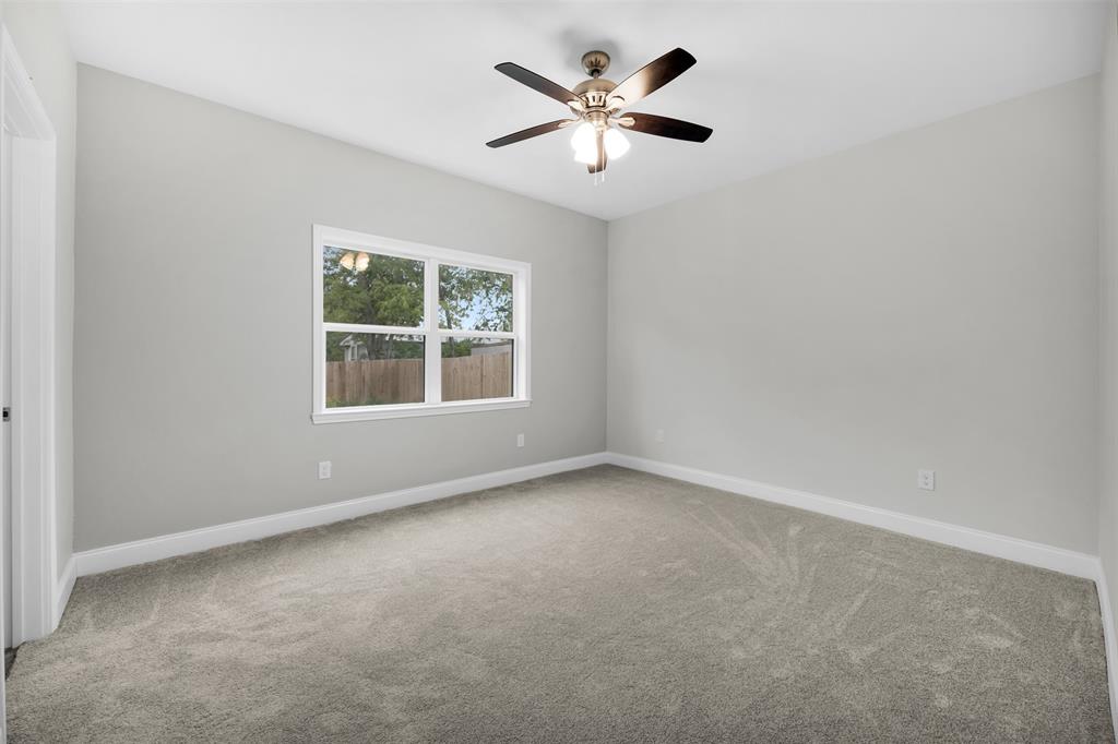 407 Dallas Street Rice, TX 75155 - Photo 13 of 25 an empty room with a window and a fan