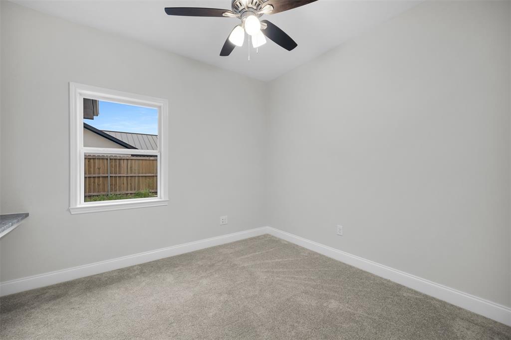 407 Dallas Street Rice, TX 75155 - Photo 17 of 25 an empty room with a window and a fan