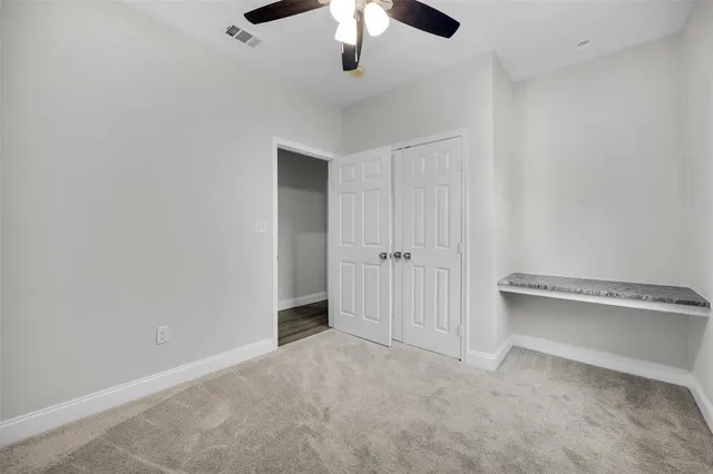 an empty room with a ceiling fan