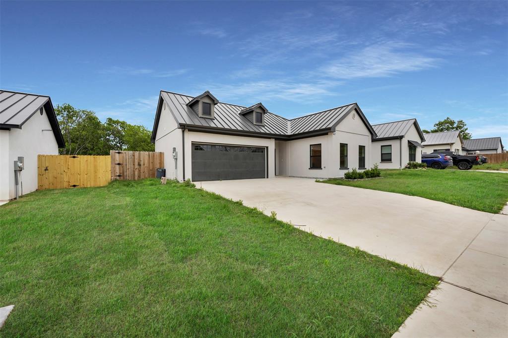 407 Dallas Street Rice, TX 75155 - Photo 2 of 25 a front view of a house with a garden and yard