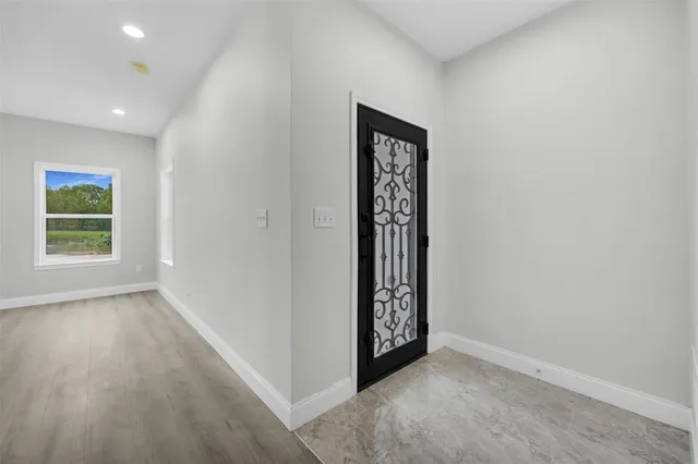 an empty room with windows and closet