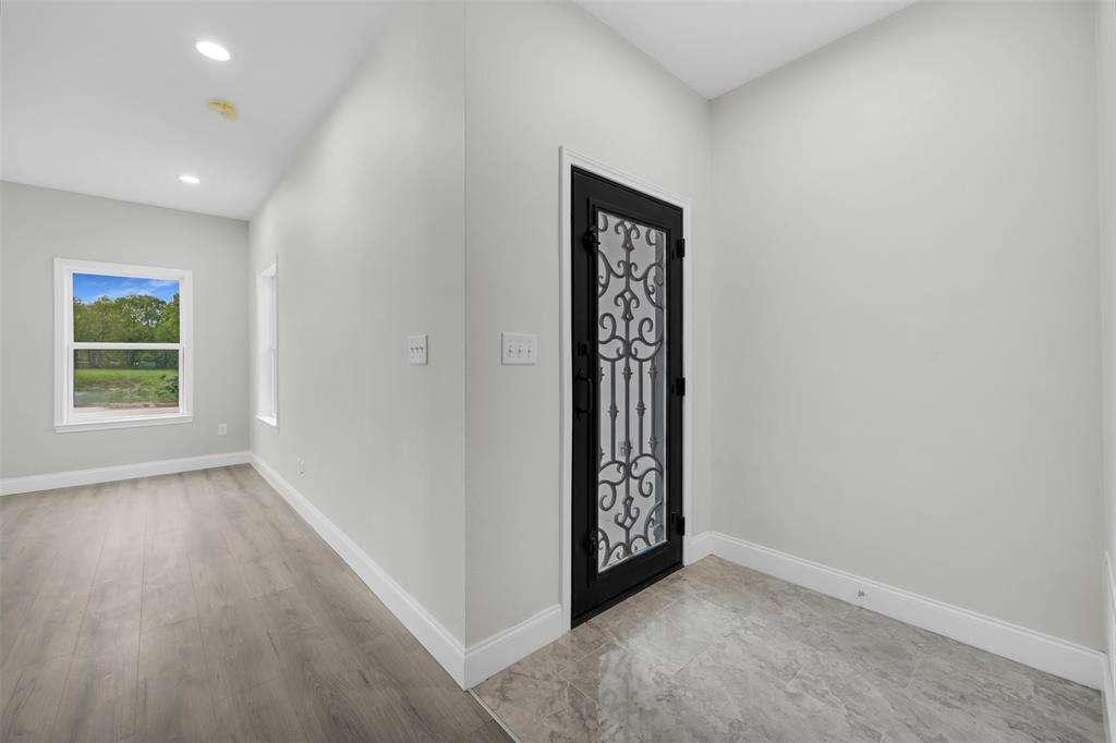 407 Dallas Street Rice, TX 75155 - Photo 5 of 25 an empty room with windows and closet