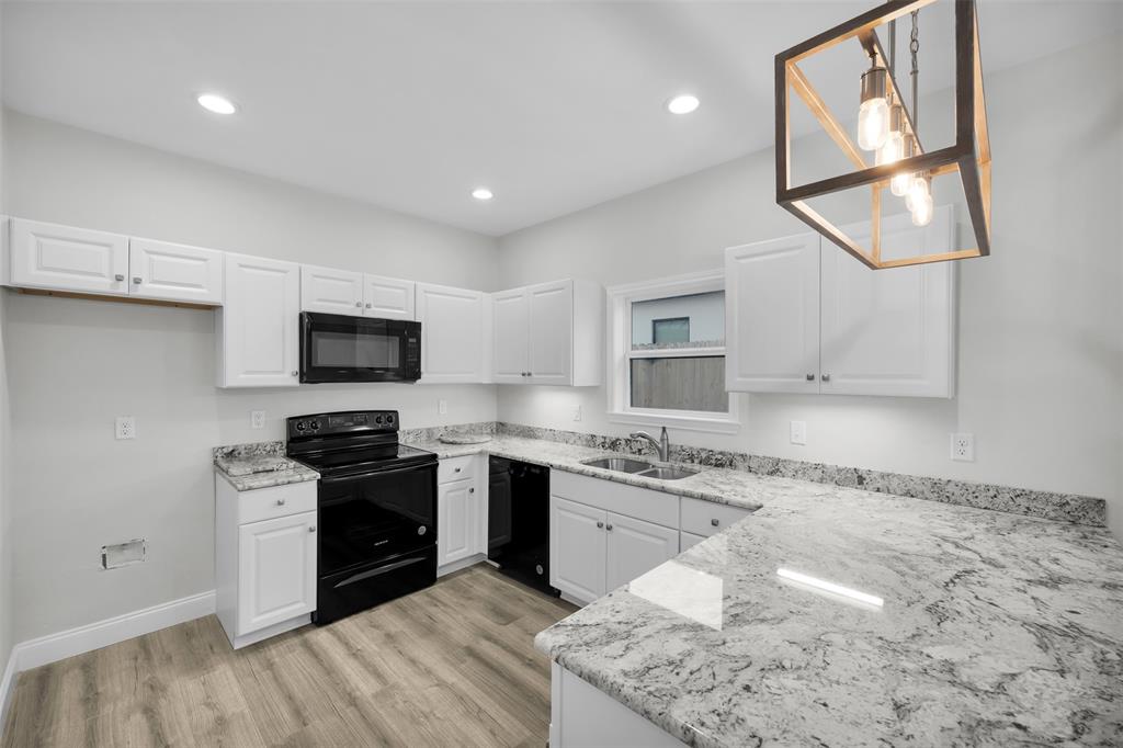 407 Dallas Street Rice, TX 75155 - Photo 9 of 25 a kitchen with stainless steel appliances granite countertop a stove and a sink