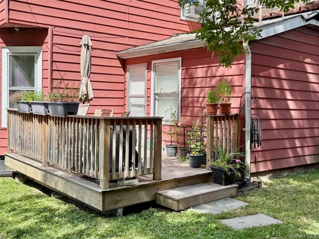 a view of a wooden deck with a small yard
