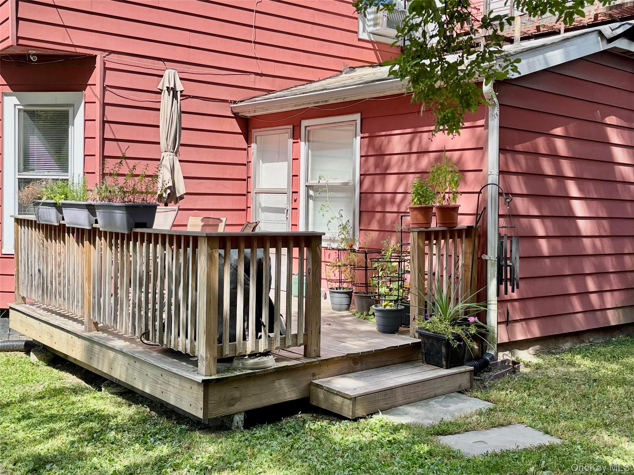 25 Carroll Street, Unit 25 Poughkeepsie, NY 12601 - Photo 3 of 11 a view of a wooden deck with a small yard