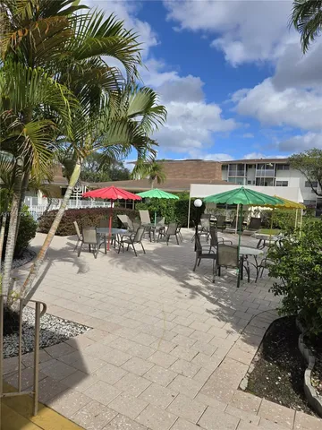 a view of a dining room with furniture and window