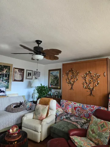 a living room with furniture and a wall painting