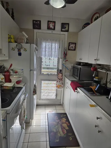a kitchen with a refrigerator and window