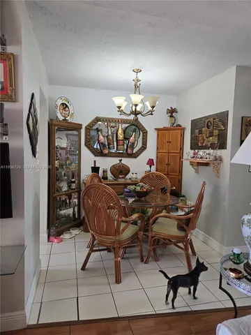 a view of a dining room with furniture and chandelier