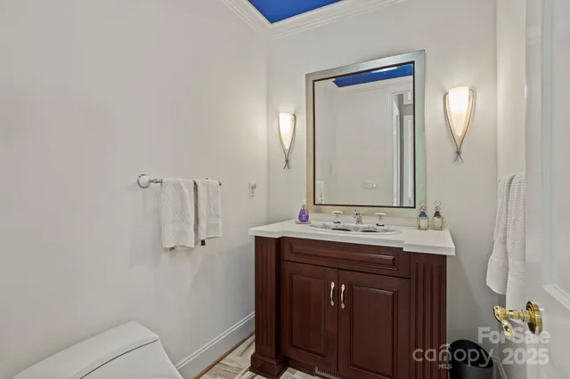 a bathroom with a sink vanity granite and a mirror