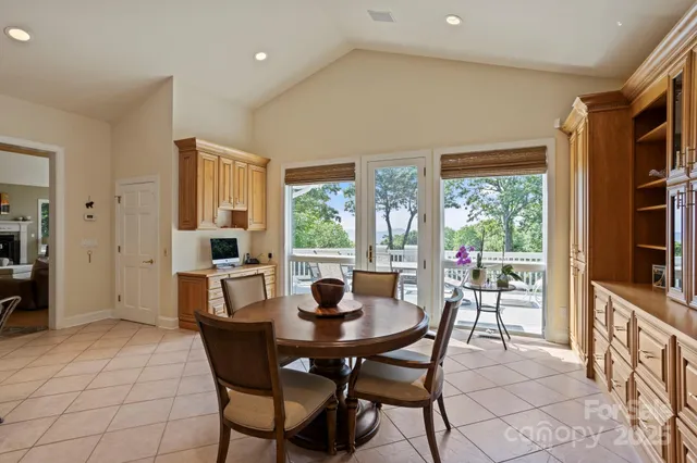 a dining room with furniture and a floor to ceiling window