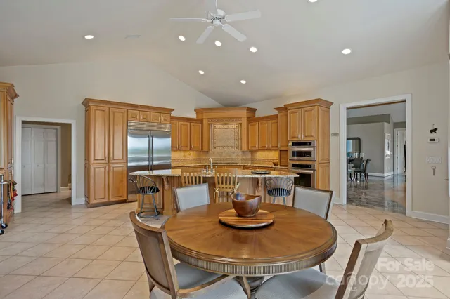 a kitchen with a dining table and chairs