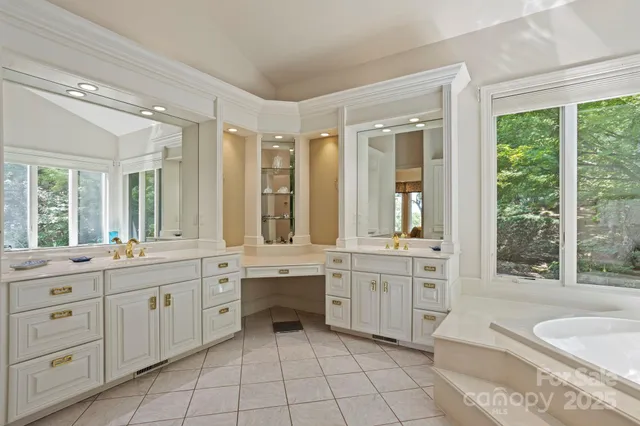 a large bathroom with a large tub sink and toilet
