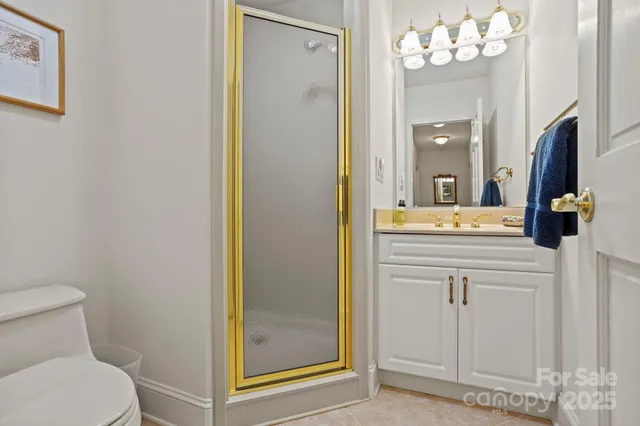 a bathroom with a sink vanity mirror and toilet