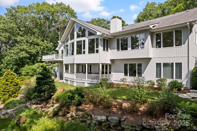 a view of a forest with mountains in the background