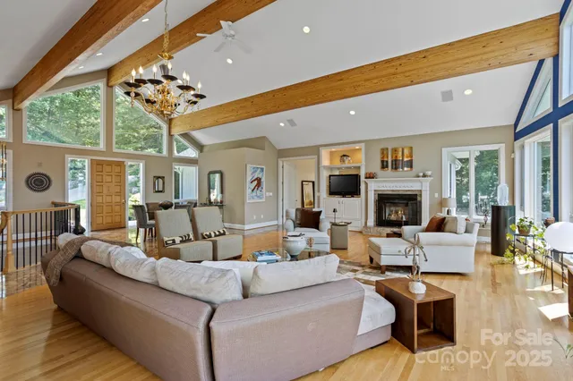 a living room with furniture fireplace and a large window
