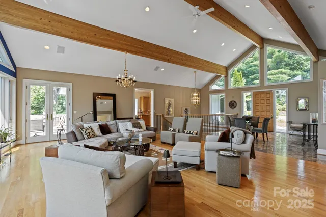 a living room with fireplace furniture and a large window