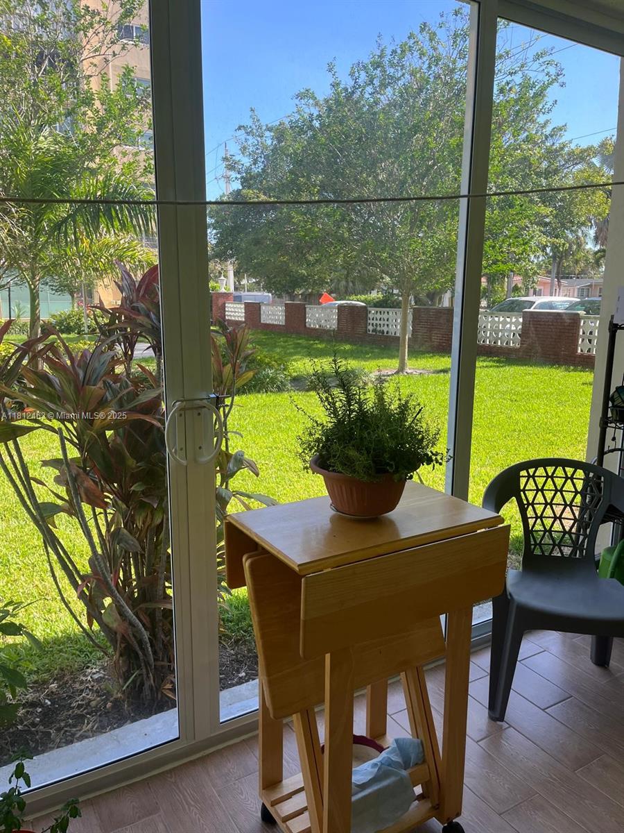 620 Northeast 12th Avenue, Unit 107 Hallandale Beach, FL 33009 - Photo 15 of 16 a view of an outdoor sitting area with furniture