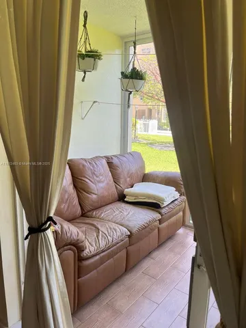 a living room with a furniture and a window