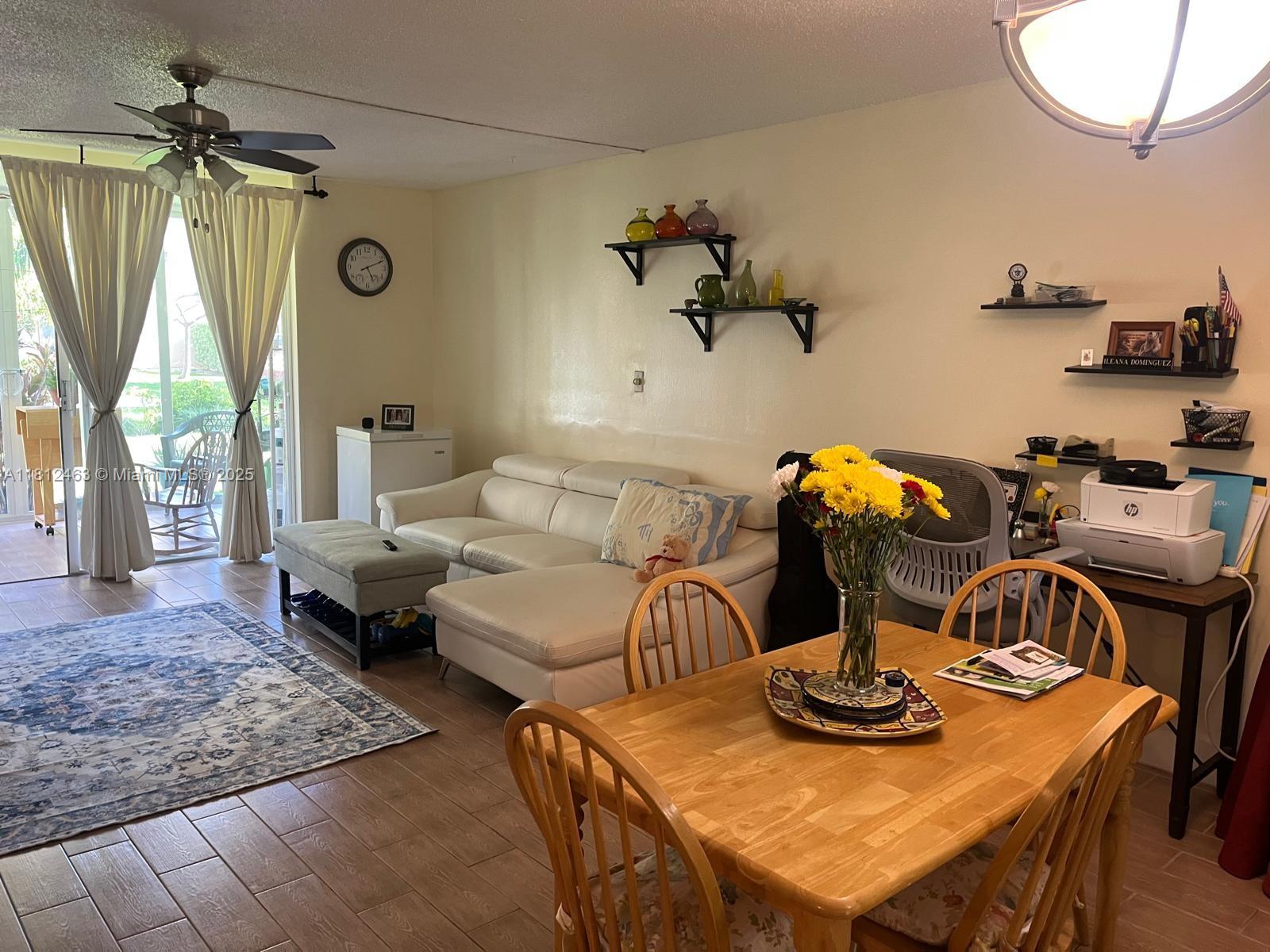 620 Northeast 12th Avenue, Unit 107 Hallandale Beach, FL 33009 - Photo 3 of 16 a living room with furniture and a window