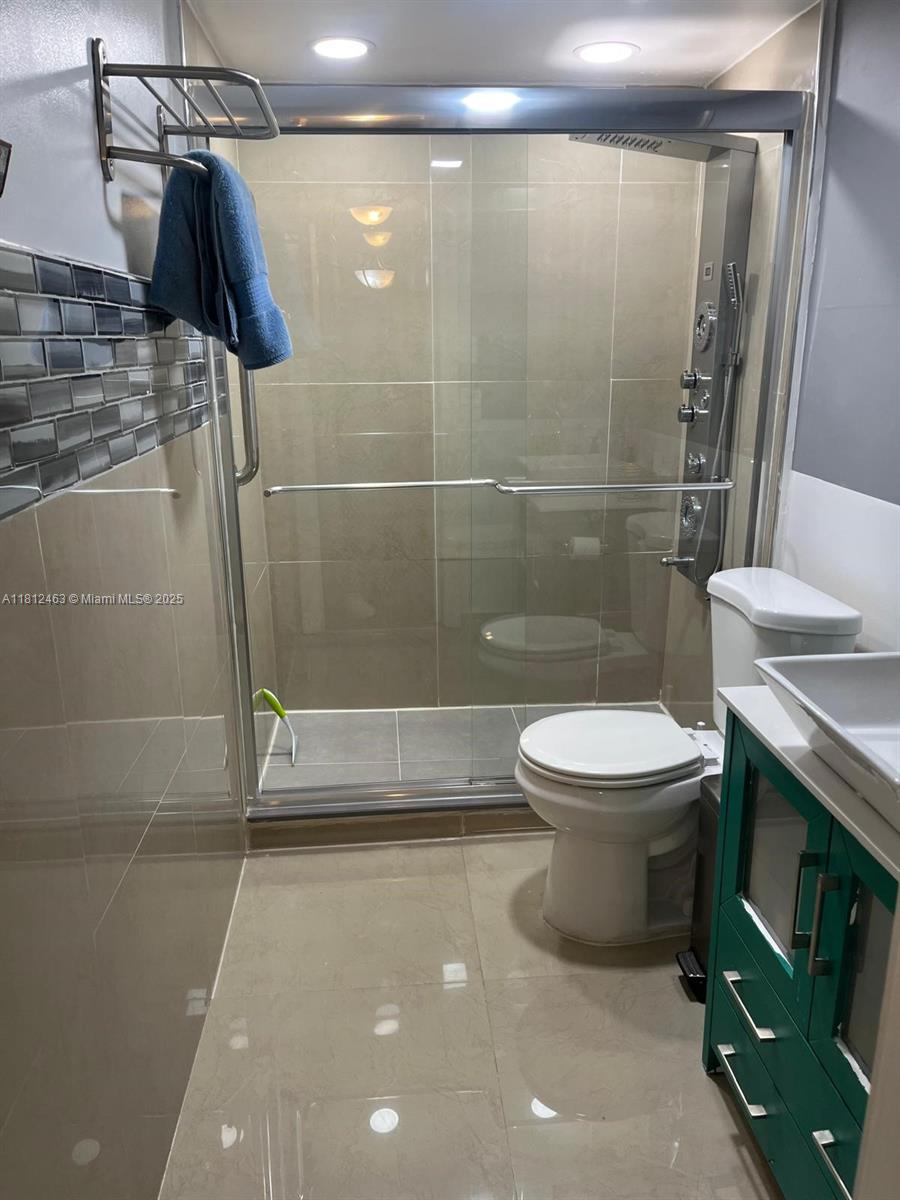 620 Northeast 12th Avenue, Unit 107 Hallandale Beach, FL 33009 - Photo 9 of 16 a bathroom with a toilet and a shower