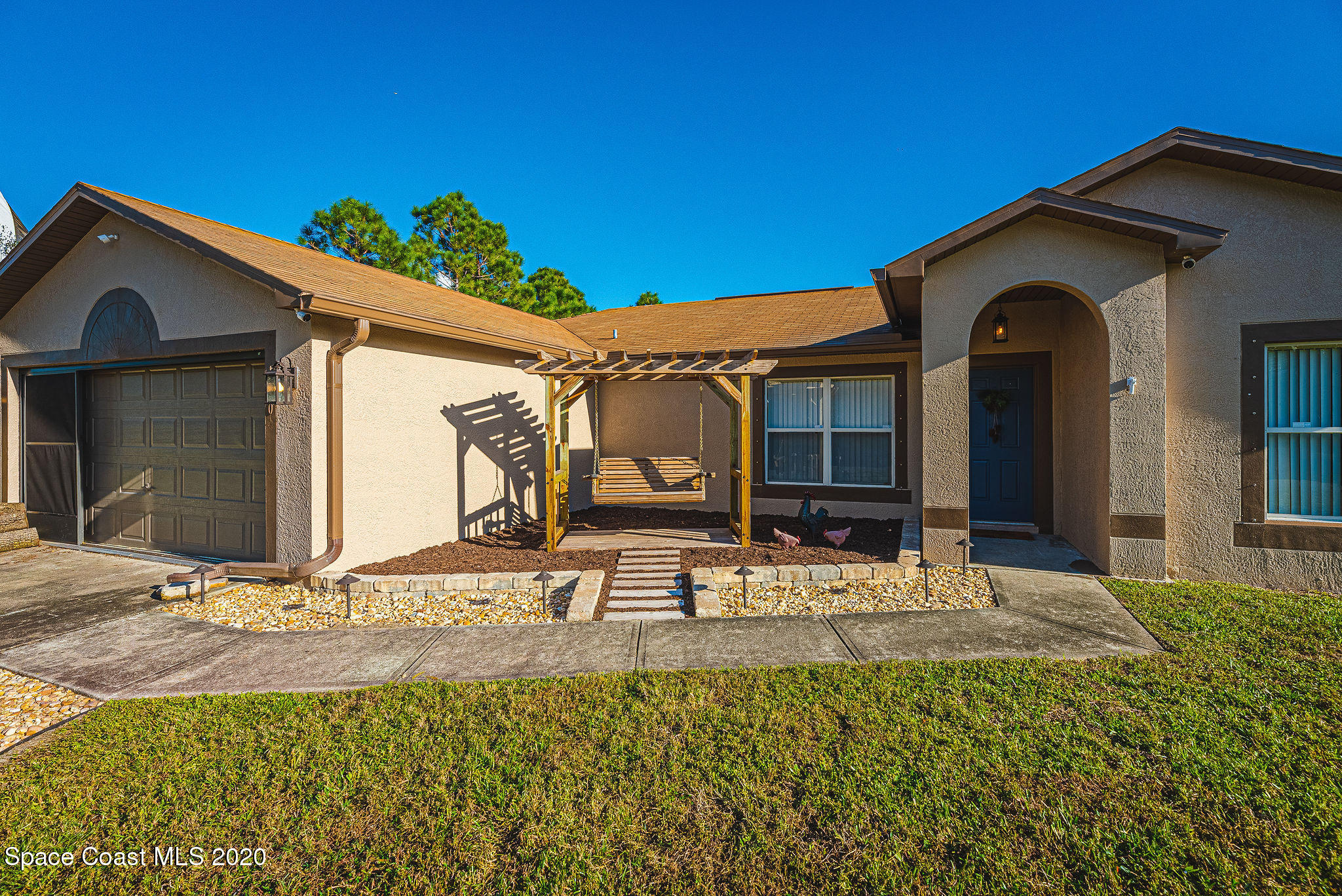 1240 Rabbit Street Southeast Palm Bay, FL 32909 - Photo 1 of 41 a front view of a house with garden