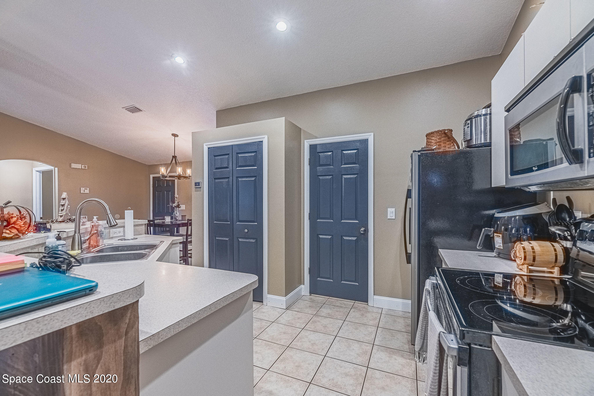 1240 Rabbit Street Southeast Palm Bay, FL 32909 - Photo 11 of 41 a kitchen with stainless steel appliances granite countertop a stove and a refrigerator