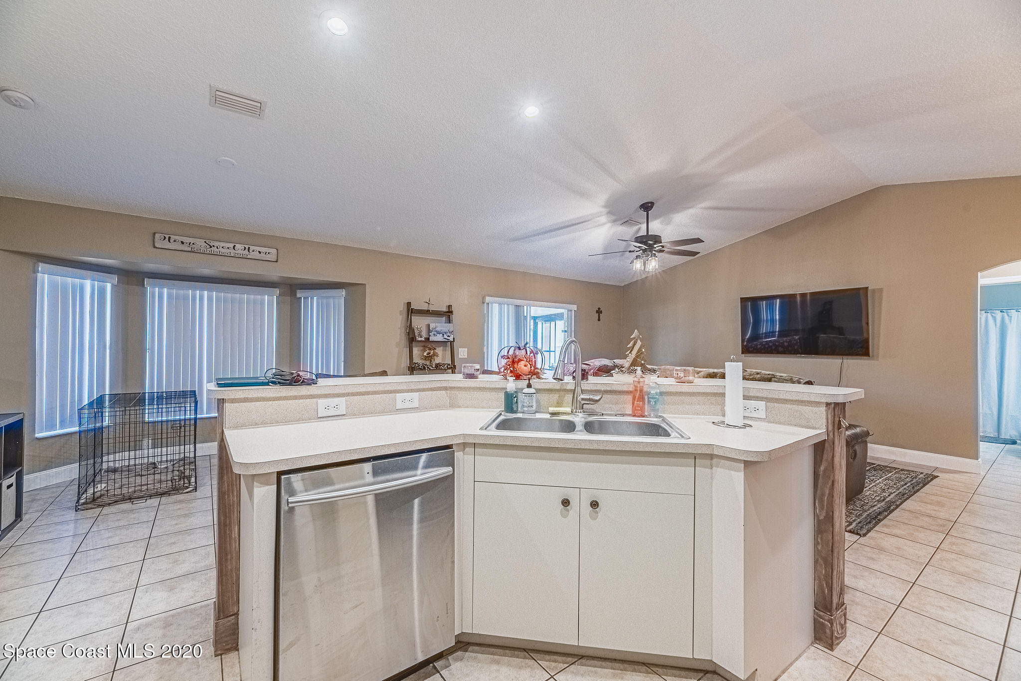1240 Rabbit Street Southeast Palm Bay, FL 32909 - Photo 12 of 41 a kitchen with a sink stove and cabinets