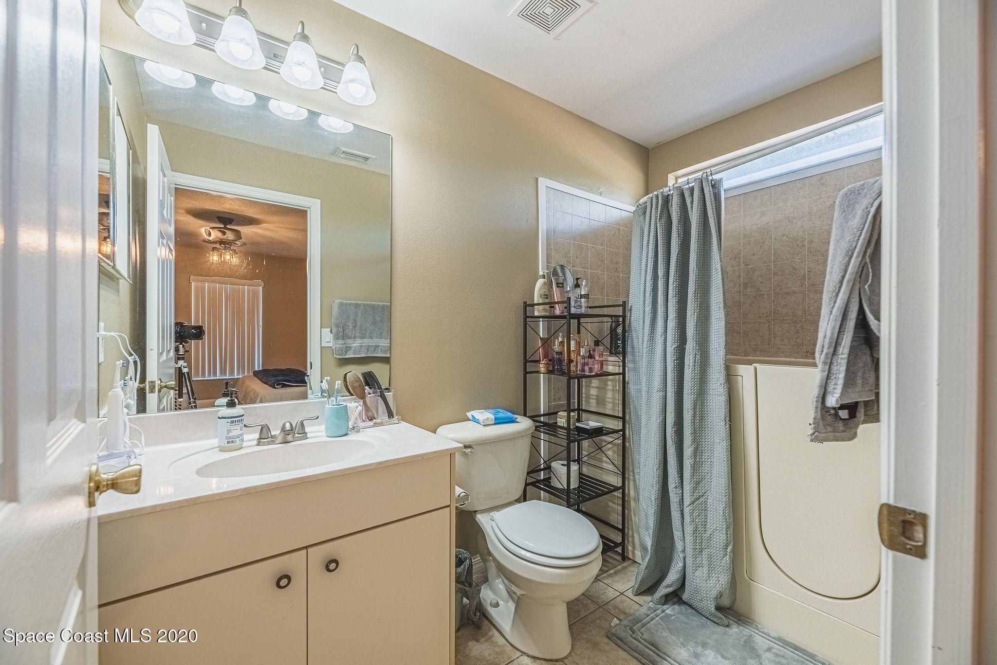 1240 Rabbit Street Southeast Palm Bay, FL 32909 - Photo 15 of 41 a bathroom with a sink a toilet a mirror and shower