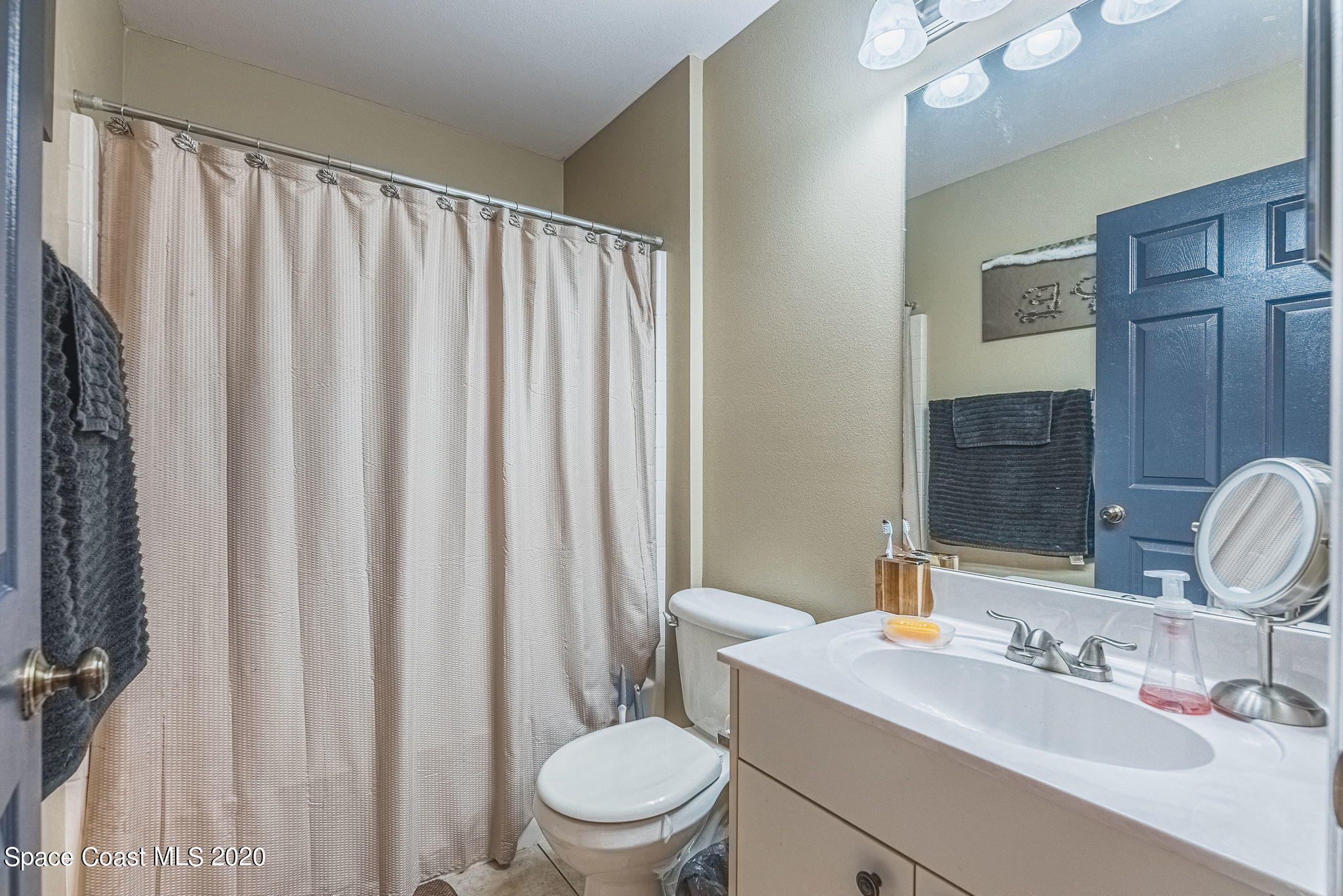 1240 Rabbit Street Southeast Palm Bay, FL 32909 - Photo 16 of 41 a bathroom with a toilet a sink and a mirror