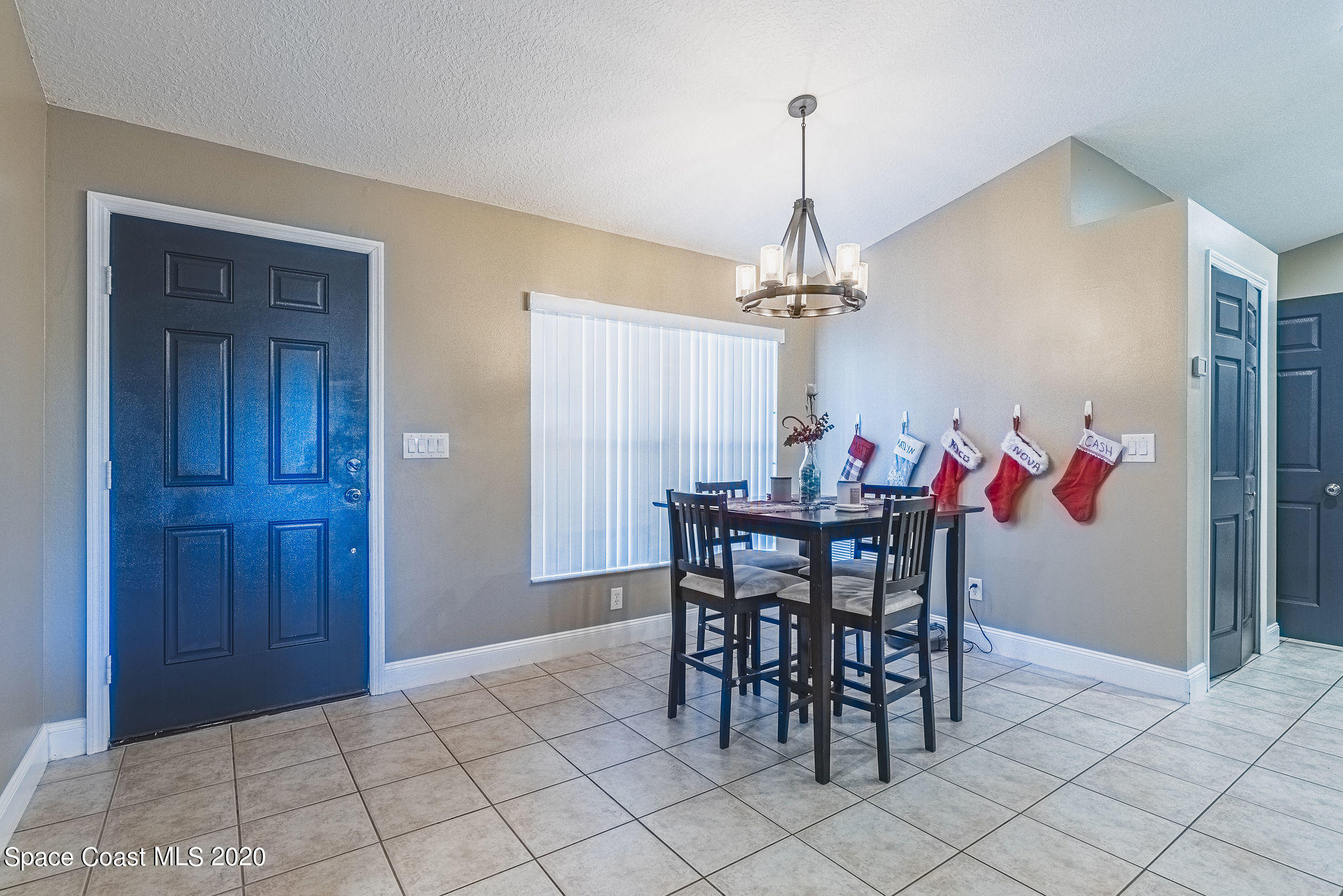 1240 Rabbit Street Southeast Palm Bay, FL 32909 - Photo 3 of 41 a view of a dining room with furniture and chandelier