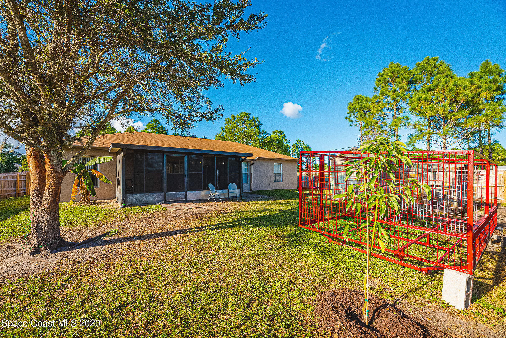 1240 Rabbit Street Southeast Palm Bay, FL 32909 - Photo 22 of 41 a front view of a house with a garden