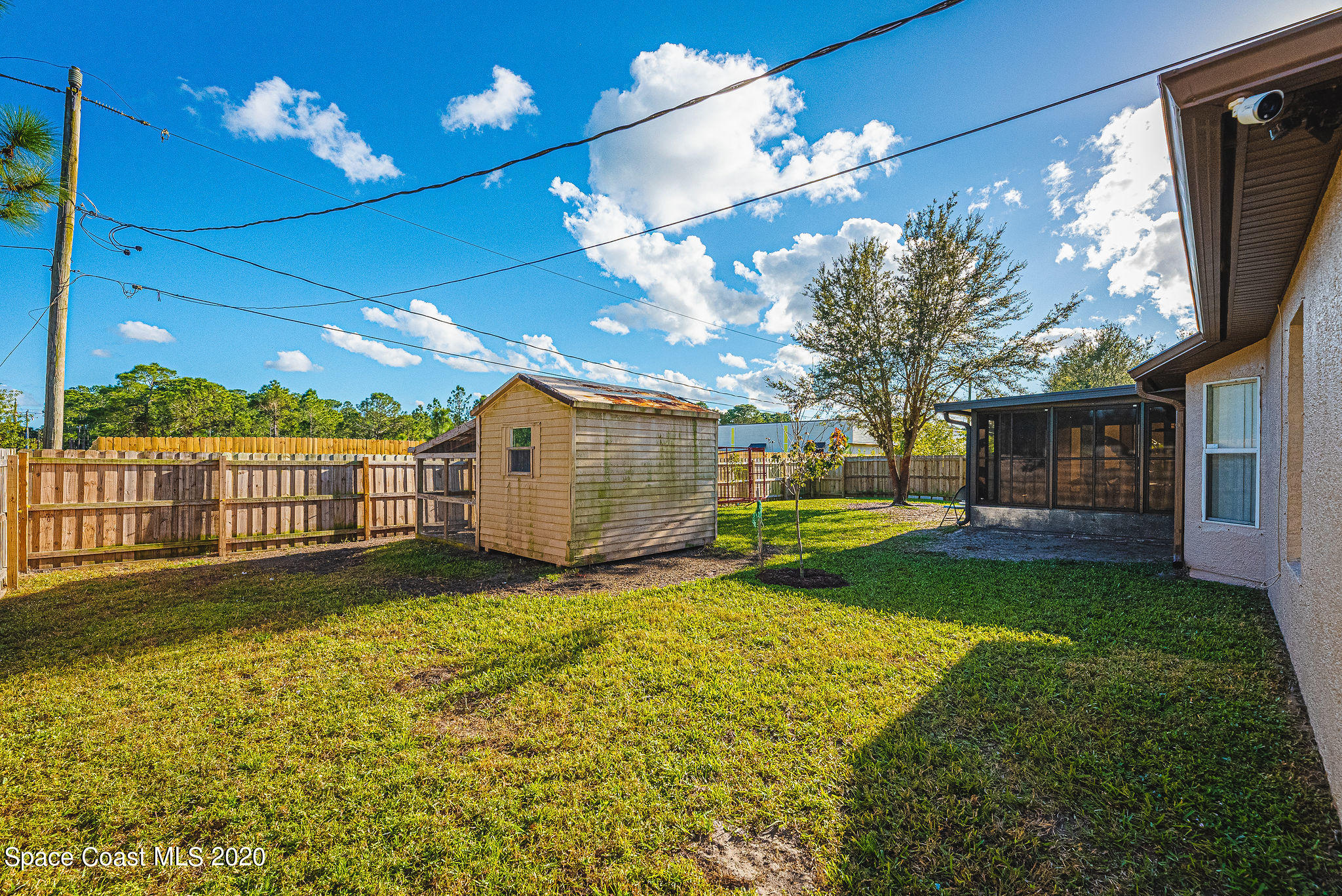 1240 Rabbit Street Southeast Palm Bay, FL 32909 - Photo 25 of 41 a view of a house with backyard and a tree
