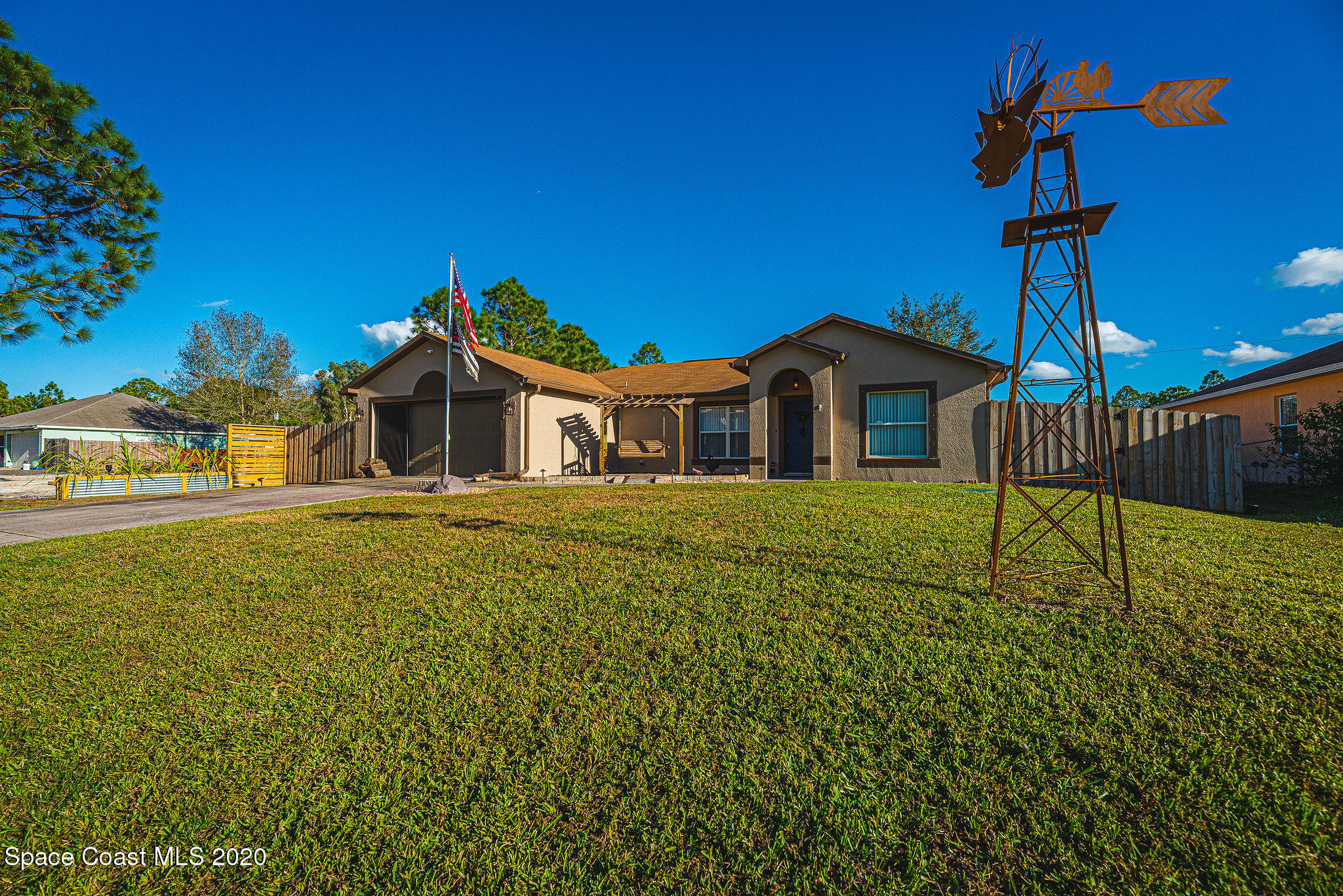 1240 Rabbit Street Southeast Palm Bay, FL 32909 - Photo 32 of 41 a house view with a garden space
