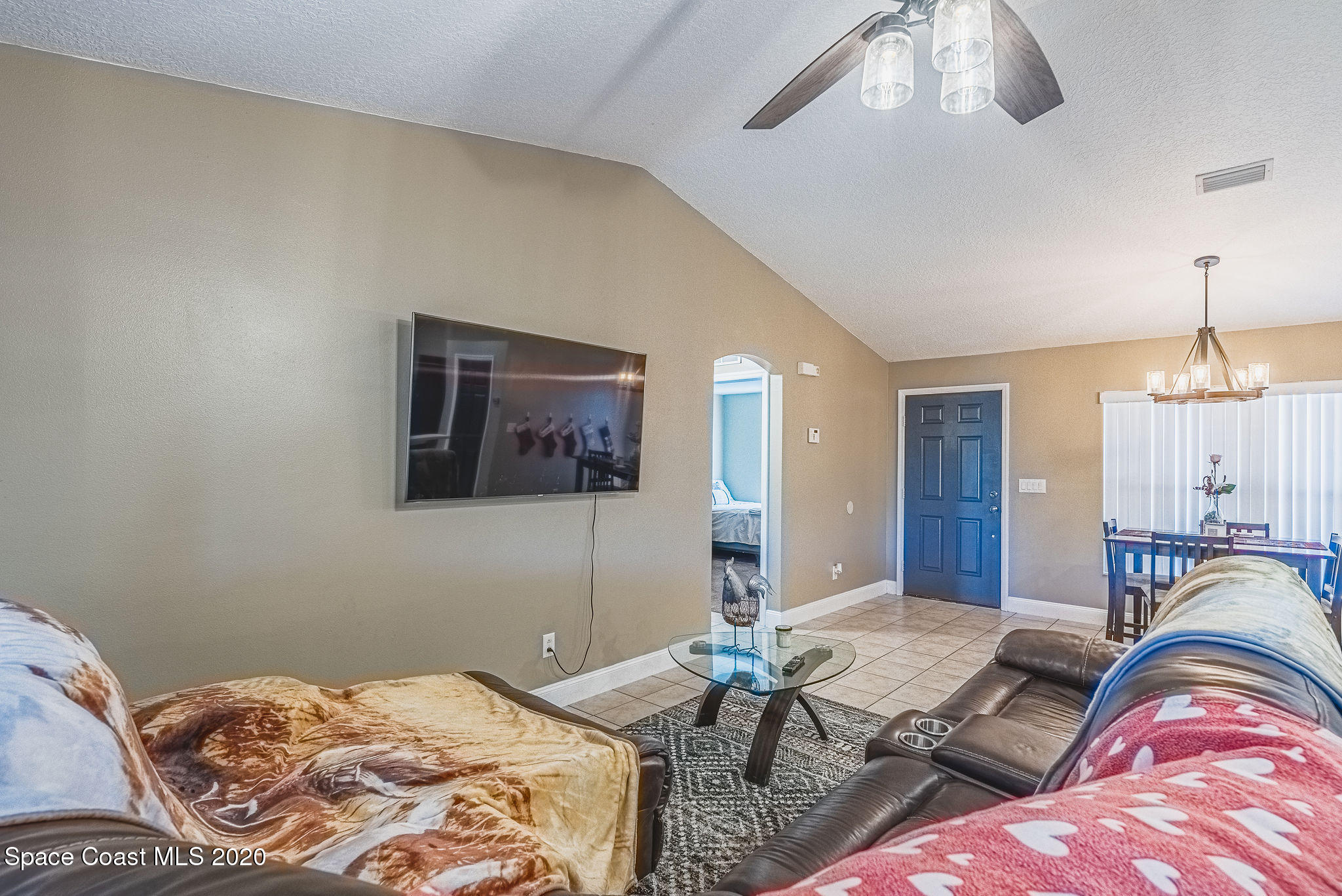 1240 Rabbit Street Southeast Palm Bay, FL 32909 - Photo 5 of 41 a bedroom with a bed and a chandelier