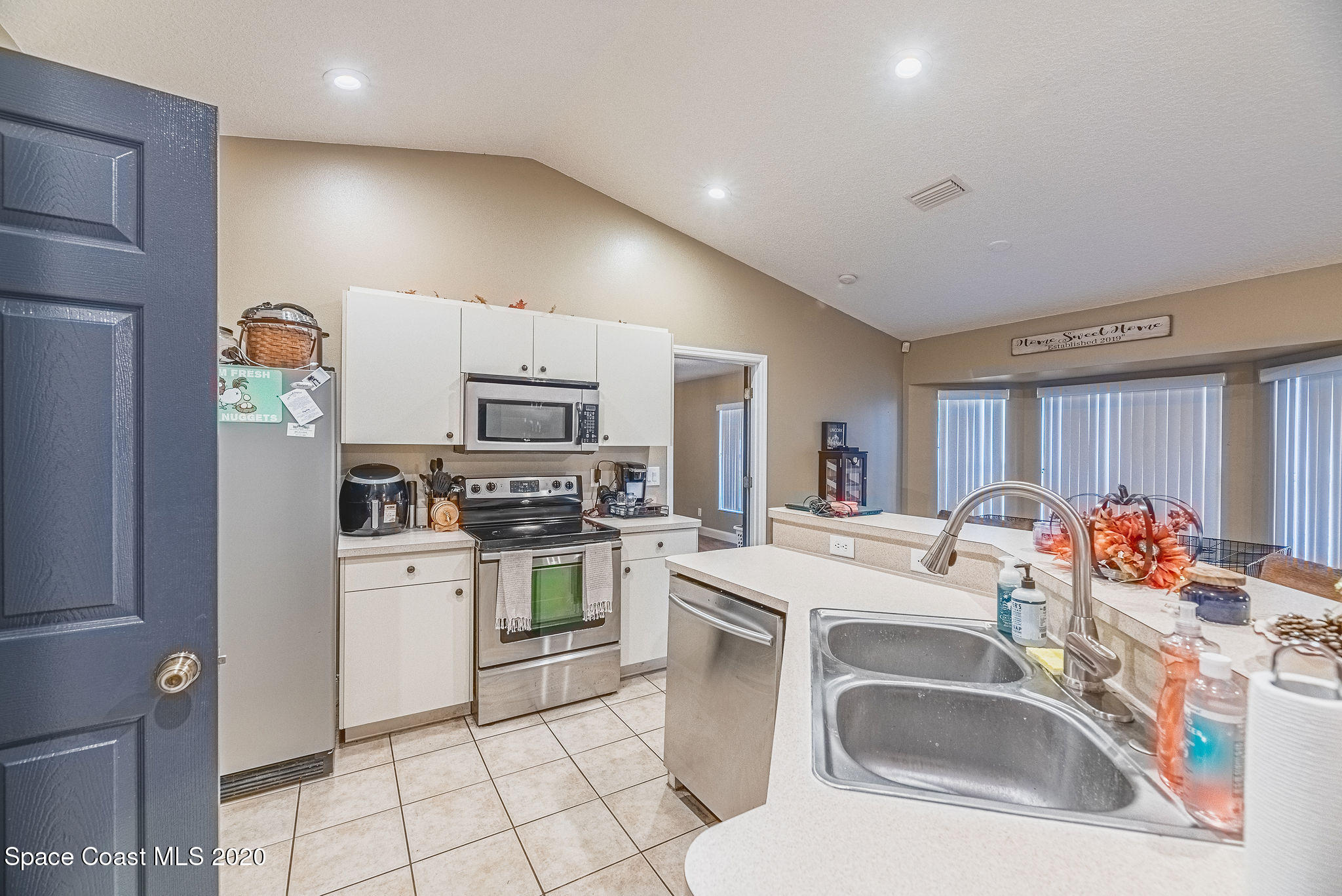 1240 Rabbit Street Southeast Palm Bay, FL 32909 - Photo 8 of 41 a kitchen that has a sink cabinets counter space and appliances