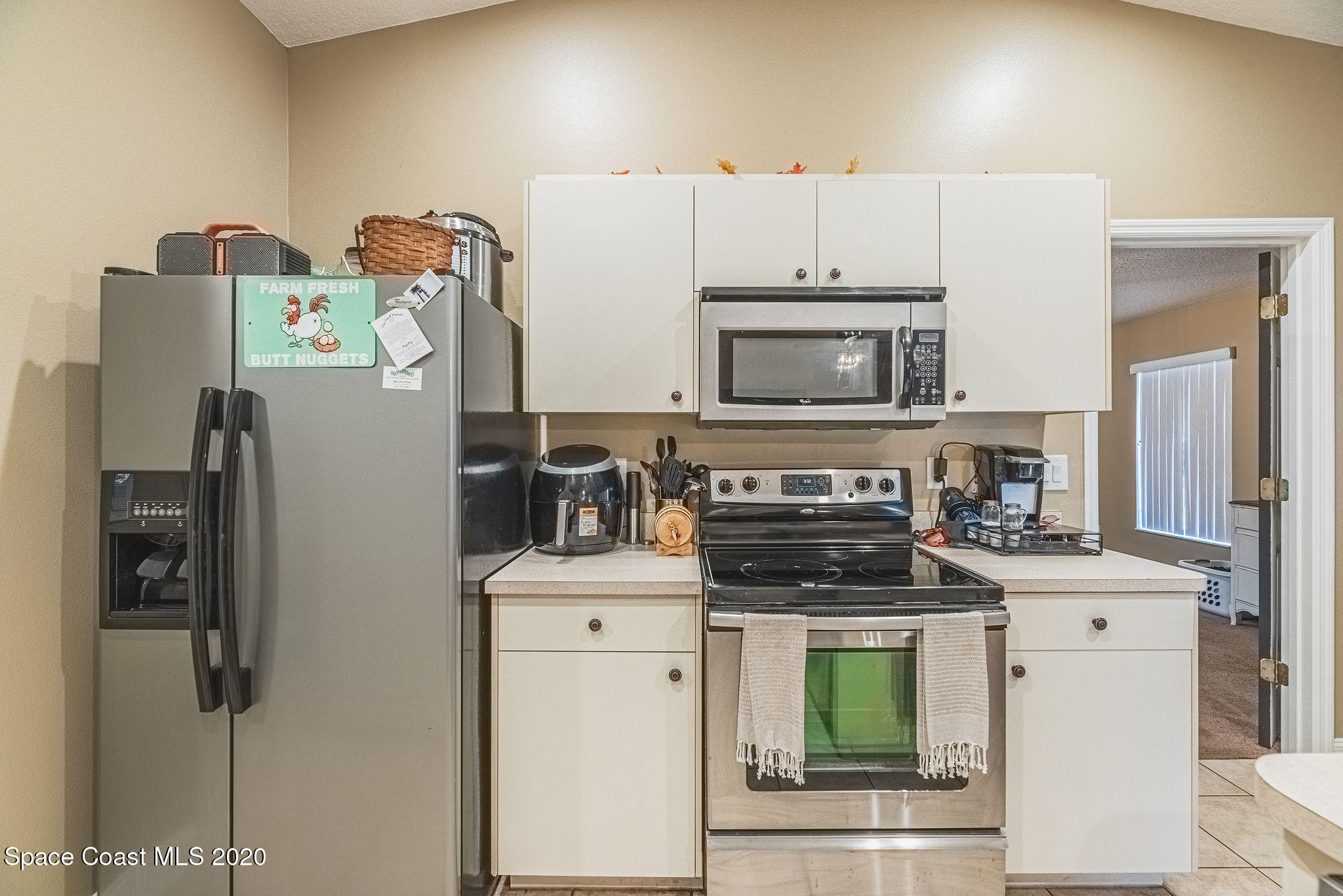 1240 Rabbit Street Southeast Palm Bay, FL 32909 - Photo 9 of 41 a kitchen with stainless steel appliances a stove a refrigerator a sink a stove and cabinets