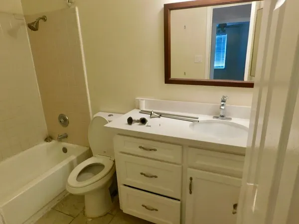 a bathroom with a sink a toilet and bathtub
