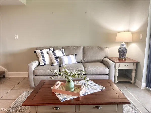 a living room with furniture and a lamp